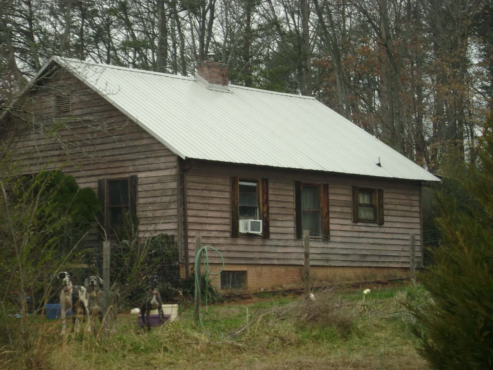 White metal roof on an old wood sided farmhouse, from a Metal Roof Installation job in Dayton